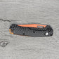 B-USA 15533or-01 M*NI TAGGED OUT CARBON FIBER W/ ORANGEBLADE KNIFE. MADE on a BENCH in Oregon