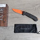 B-USA 15535or-01  TAG*ED OUT CARBON FIBER W/ ORANGEBLADE KNIFE. MADE on a BENCH in Oregon
