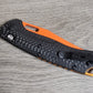 B-USA 15535or-01  TAG*ED OUT CARBON FIBER W/ ORANGEBLADE KNIFE. MADE on a BENCH in Oregon