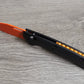 B-USA 15535or-01  TAG*ED OUT CARBON FIBER W/ ORANGEBLADE KNIFE. MADE on a BENCH in Oregon
